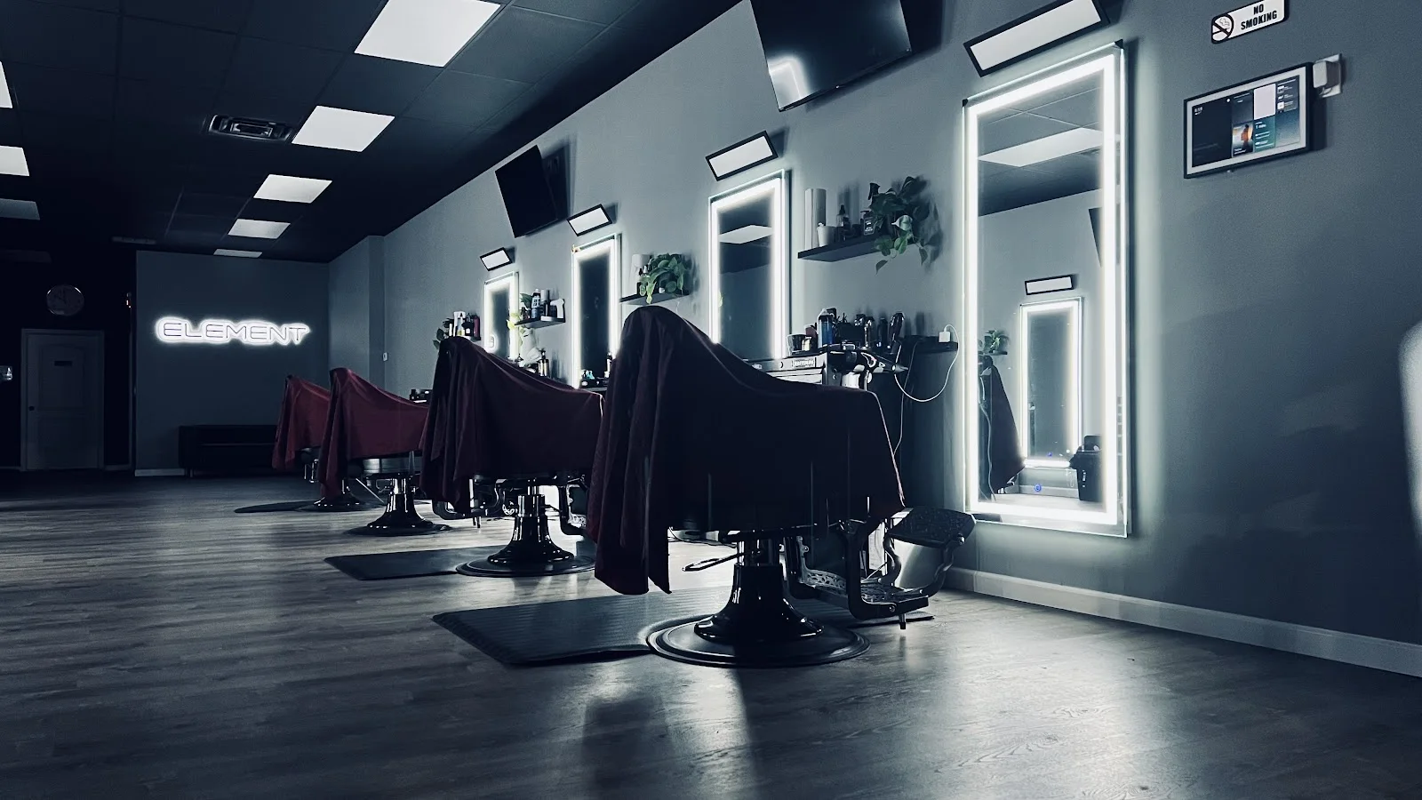 Interior of Element Barber Studio with barber chairs and illuminated mirrors